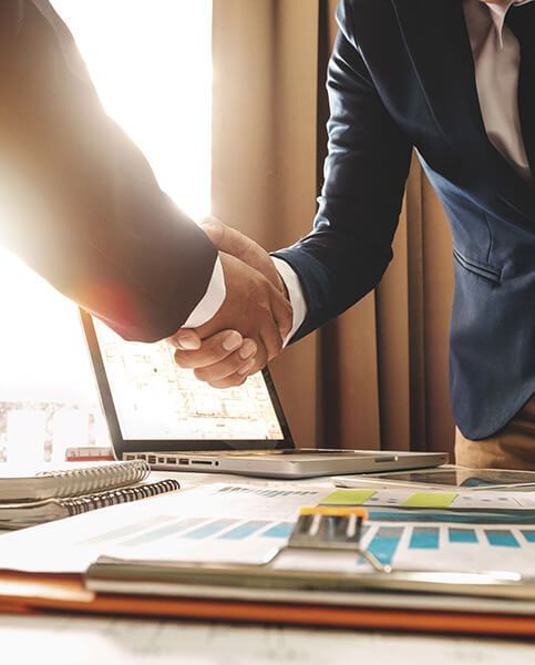 Two confident business man shaking hands during a meeting in the office, success, dealing, greeting and partner in sun light